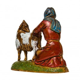 Woman Kneeling Milking a Goat