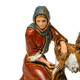 Woman Kneeling Milking a Goat